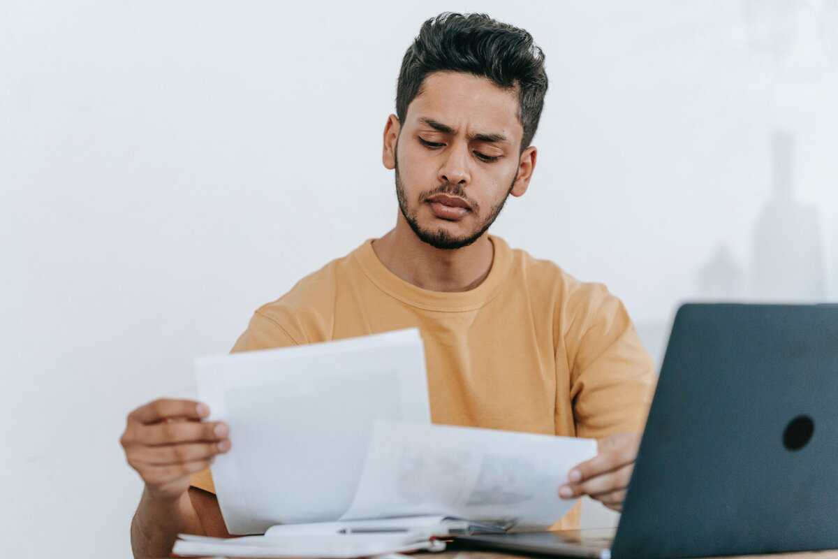 A person reviewing two papers.