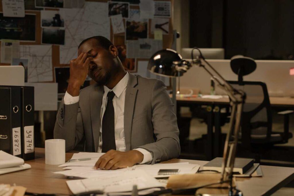 A person sitting with multiple documents spread across their desk.