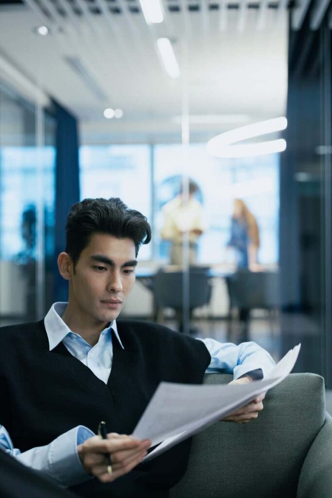 A person reviewing two documents.