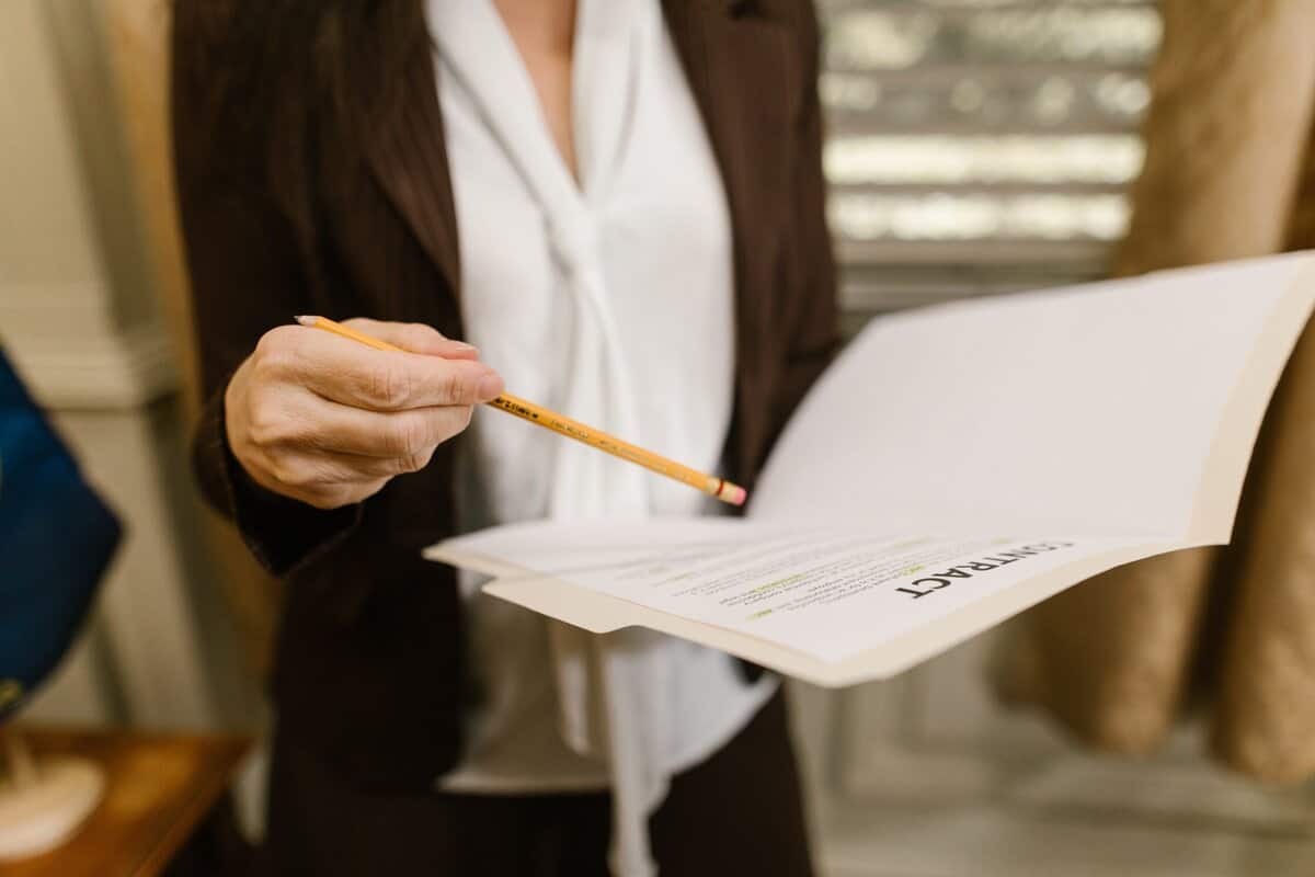 A person holding a file and pointing at it.