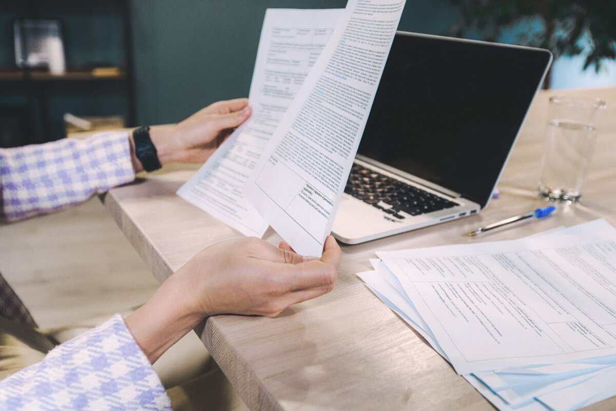 A person holding up two different documents.