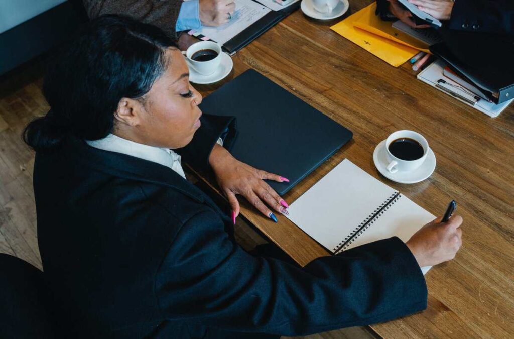 A person writing a list at a desk.