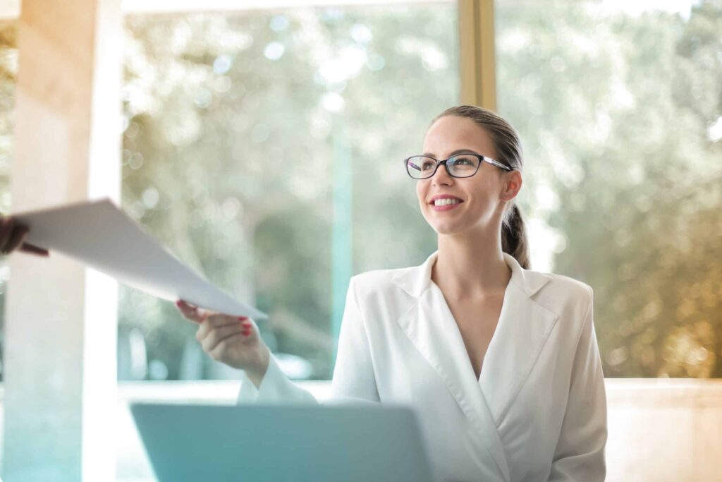 Woman handing paper